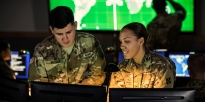 Soldiers inside of a Cyber room.