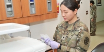Soldier prepping dental equipment.
