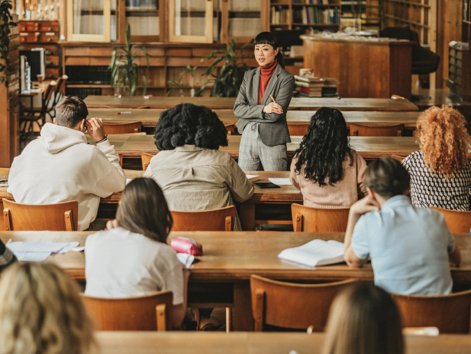 A female professor standing in front of a class