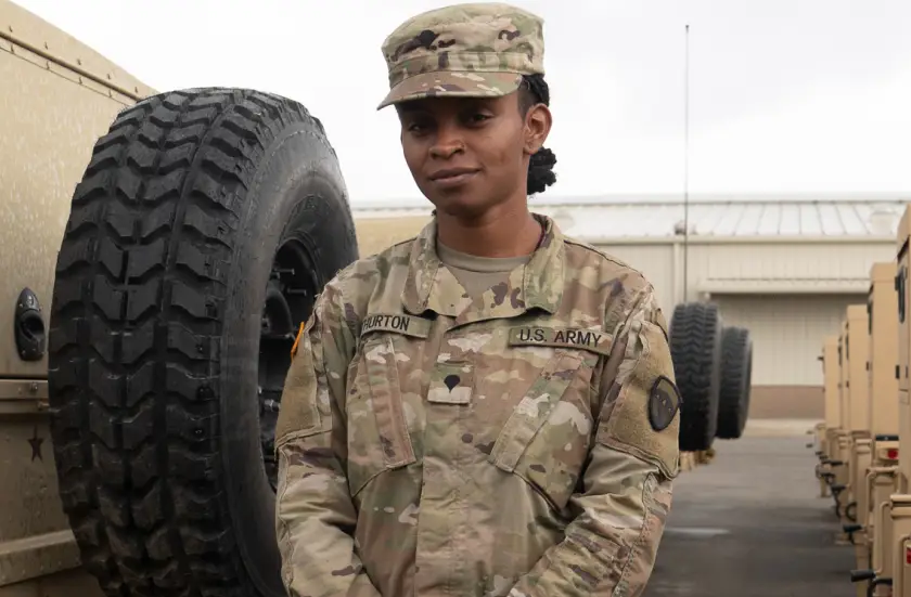 A female Army Reserve Soldier standing in a parking lot