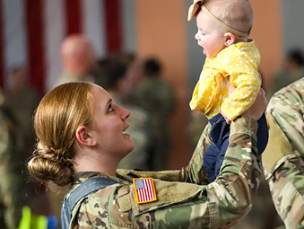 Female Soldier holding a baby