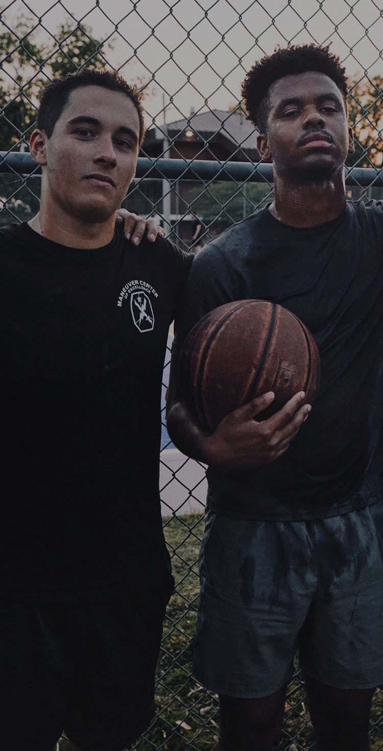 Soldiers in training standing side by side on a basketball court