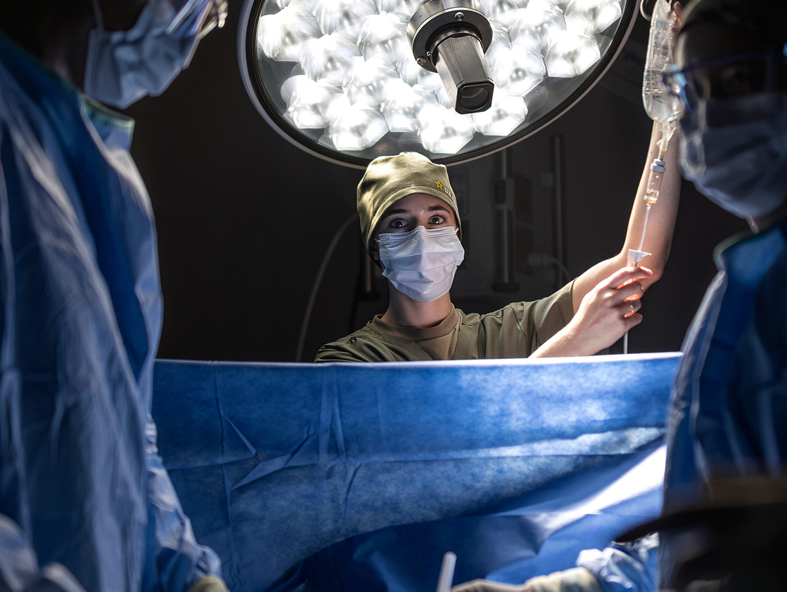 Three Army Medicine doctors wearing masks in an operating room