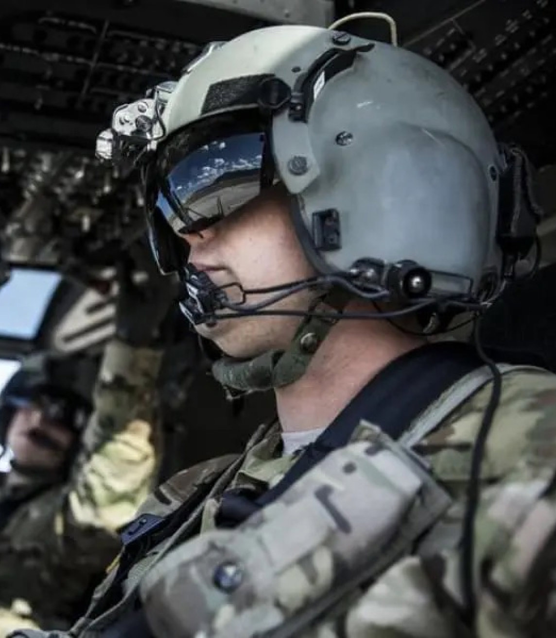Helicopter pilot sits in cockpit with co-pilot