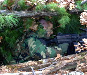 The Charles River Battalion keeps close ties with the other ROTC units at Boston University. Here, an Air Force cadet assists the army with a training event. As the opposing force in a field training exercise, he will act as the enemy to a squad of cadets. He can be seen in a bunker that was built by other Army cadets.