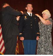 Parents of newly commissioned 2nd Lieutenant Kyle Chamberlin, pin his rank during the Marauder Battalion's Commissioning Ceremony.