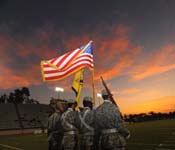 As a future officer, you’ll represent the nation within your community. Here, the ROTC Color Guard opens a college football game.