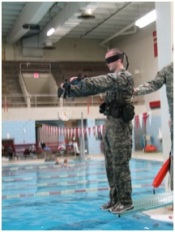 Cadet Matthew Pugh prepares to take the plunge off the diving board while blindfolded as part of the CWST training. This is just one of the events for this test which are designed to challenge the cadets and build confidence in the water.