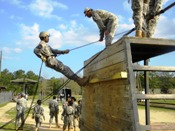 Cadets practice on the mini-wall before Rappelling off Eagle Tower at Fort Benning Georgia.