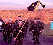Ranger Challenge is an intercollegiate sport which requires both physical and intellectual dexterity to successfully accomplish all required tasks. Cadet Chad Pilker carries the guidon for the team during the 10 kilometer foot march.