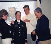 A senior Cadet is being “pinned” Second Lieutenant by her family during a recent Commissioning Ceremony.
