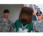 The Thundering Herd Cadre are spending time with the Marshall University mascot “Marco”