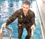Cadet Ryan Dittmer exits the pool after successfully completing combat water survival training.