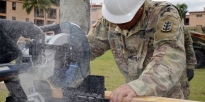 Soldier using a circular saw to cut a board to size.