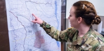 Soldier identifies a location on a map.