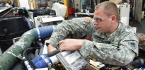 U.S. Army Soldier repairs equipment